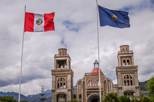 Huaraz colonial cathedral and Peru flag – Ancash province, Peru