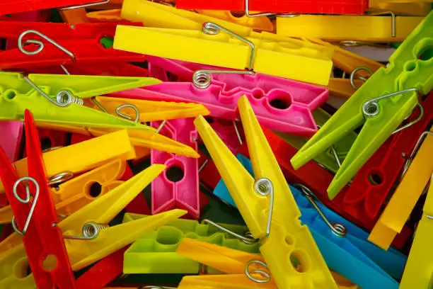 Background with several colorful and plastic clothespins