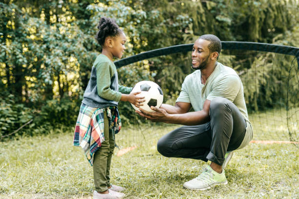 istock Dad playing soccer with daughter 1288919352