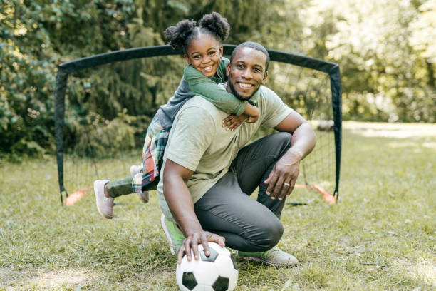 istock Dad and daughter outdoor playing soccer 1288919355