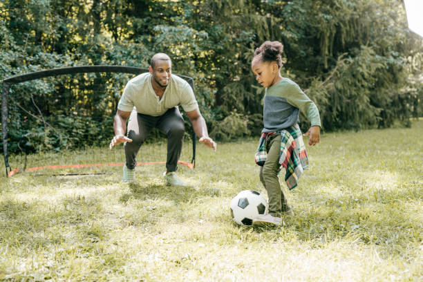 istock Dad playing soccer with daughter 1288919359