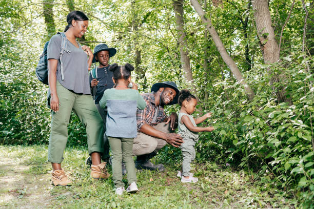 istock Summer school - learning about nature during the hike with parents 1288919415