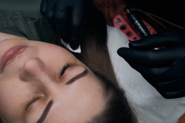 istock Permanent eyebrow makeup procedure. Eyebrow tattooing, process. The use of tools by a master for permanent eyebrow makeup. 1288921065