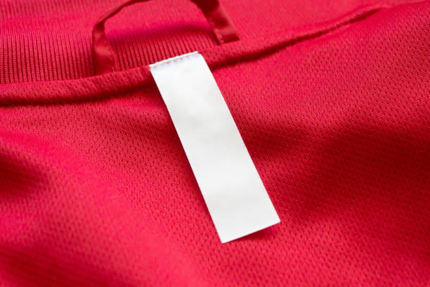 istock White blank clothes label on red jersey texture background 1288921198