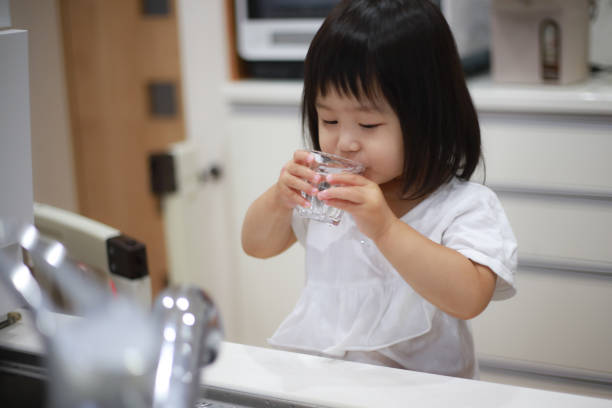 istock Girl drinking tap water 1288924417