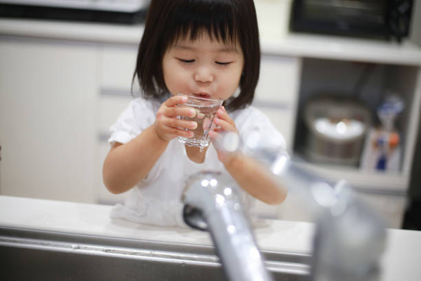istock Girl drinking tap water 1288924452