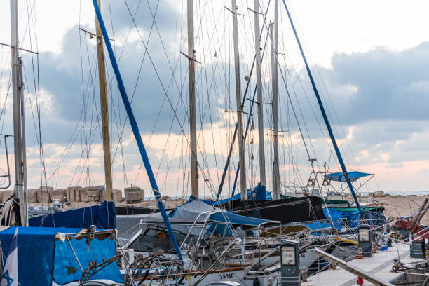 view of marina with yachts in the old jaffa port, one of the oldest known harbors in the world, located in the southern part of tel aviv israel in the afternoon - sailboat sunset tel aviv sea imagens e fotografias de stock