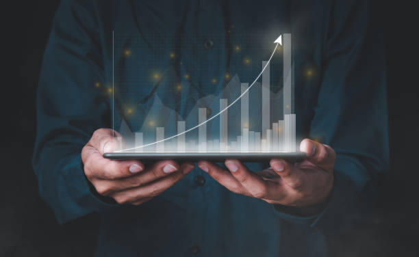 istock A man is working with a laptop. The other hand holds the globe, graphics, and stock chart. Investment ideas, business concepts, technology concepts. 1288931786
