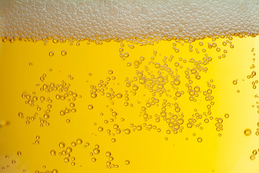 beer foam in glass with cold bubbles