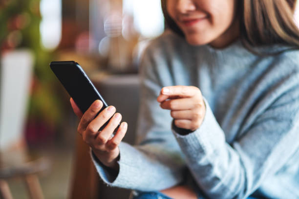 istock a beautiful young asian woman holding and using smart phone 1288934862