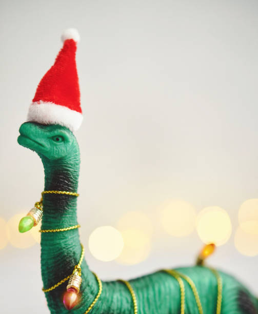 istock Christmas Background with Dinosaur Wrapped in Christmas Lights 1288936380
