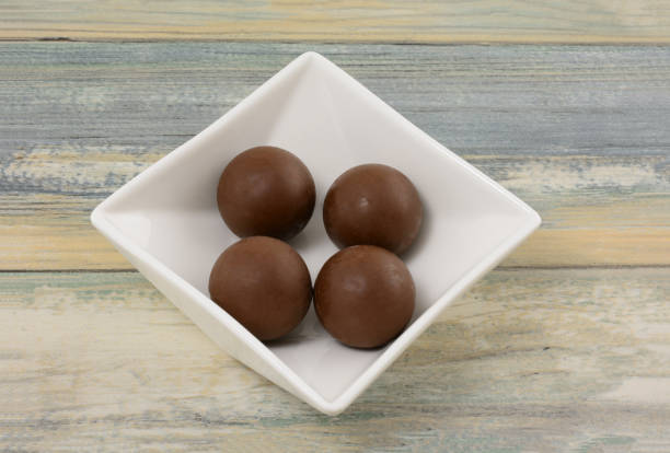 the Set of chocolate bombs, marshmallow filling and white chocolate on white background
