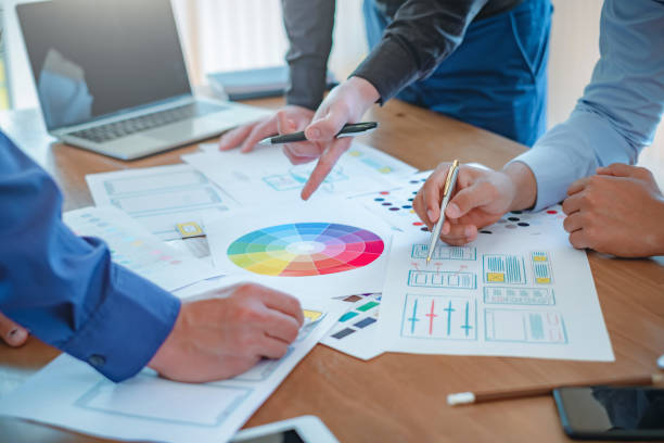 istock Group of young  designers drawing website ux app development on mobile phone. 1288938803