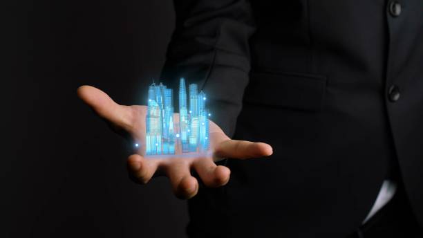 istock Businessman holds 3D city model showing augmented reality technology 1288939685