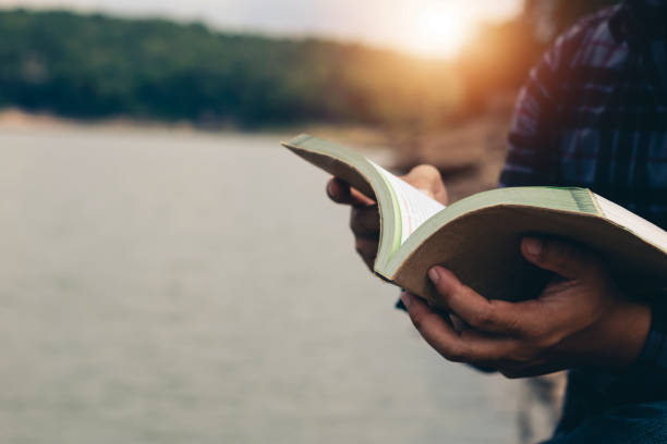 istock Men read book in the holiday in quiet nature, Concept reading a book. 1288940819