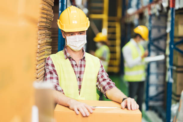 istock Diversity warehouse worker wear face mask as new normal after Covid 19 1288942660