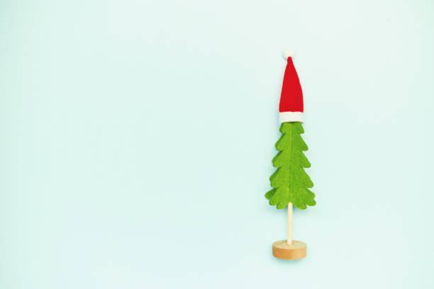 Simple Holiday Background with Christmas Tree and Santa Hat