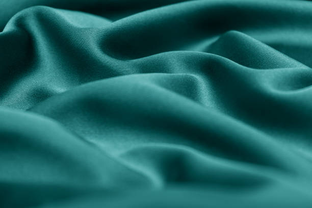istock Creative background of green silk. Abstract texture.Selective focus with shallow depth of field,blurred foreground 1288944807