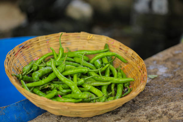 Fresh green chilly in wooden bowl.