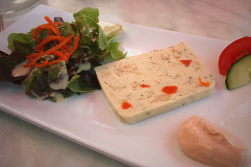 Fish galantine served with ketchup mayonnaise and seasoned green salad