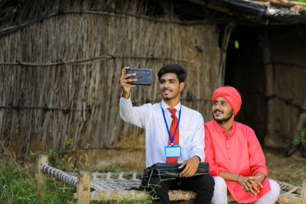 istock Young Indian agronomist taking selfie with farmer 1288948235