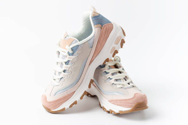 Pastel sneakers on white background copy of space, front view