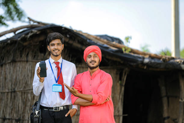 istock Young Indian bank officer showing mobile screen with farmer 1288950194