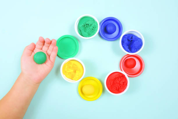 istock colored mass for modeling for children's creativity, molded green ball in a child's hand, selective focus 1288950222