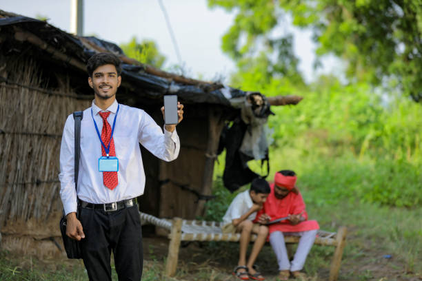istock Young indian bank officer showing mobile screen with farmer 1288952939