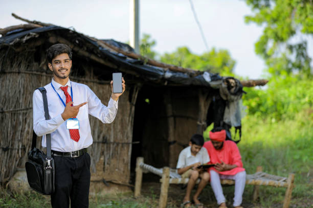 istock Young indian bank officer showing mobile screen with farmer 1288952966