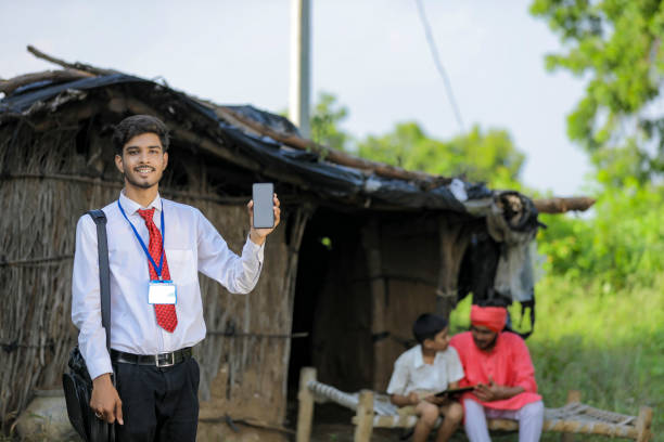 istock Young indian bank officer showing mobile screen with farmer 1288952991