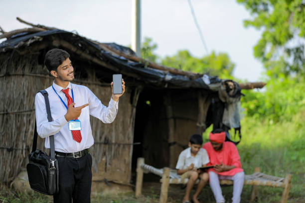 istock Young indian bank officer showing mobile screen with farmer 1288953017