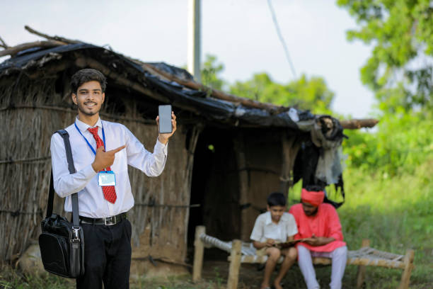 istock Young indian bank officer showing mobile screen with farmer 1288953698