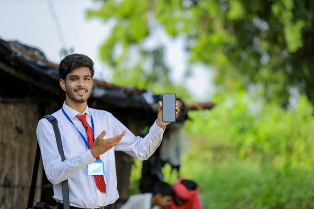 istock Young indian bank officer showing mobile screen with farmer 1288953718