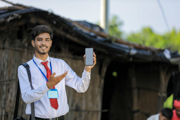 Young indian bank officer showing mobile screen with farmer