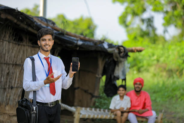 istock Young Indian bank officer showing mobile screen with farmer 1288953949