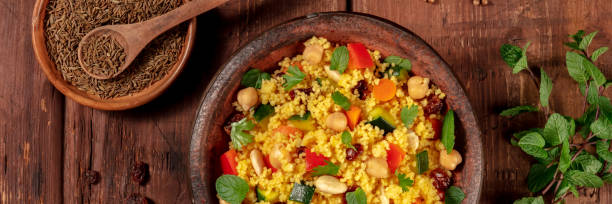 istock Couscous flat lay panorama on a dark wooden background 1288956800