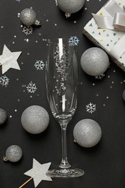 istock New year accessories and champagne glass on black background 1288956841