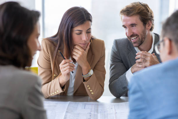 istock Business partners sitting at conference table and discussing new project 1288957469