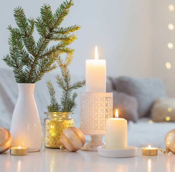 istock Christmas decorations with burning candles in white interior 1288957697