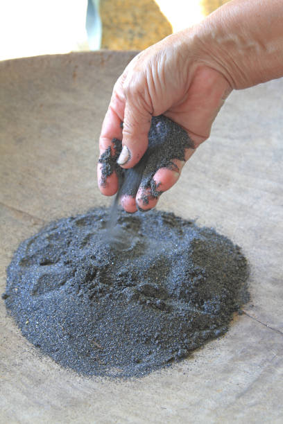 the Hand is holding tin ore stock photo