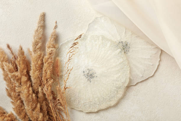 istock Epoxy resin, fabric and field flowers on white background 1288958924