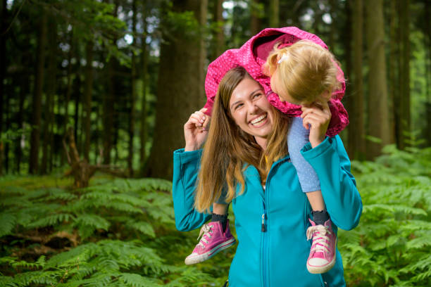 istock Mother carrying her daughter 1288959591