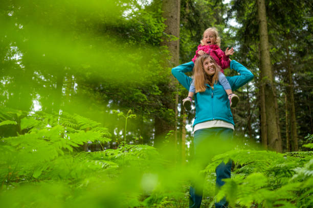 istock Mother carrying her daughter 1288959742