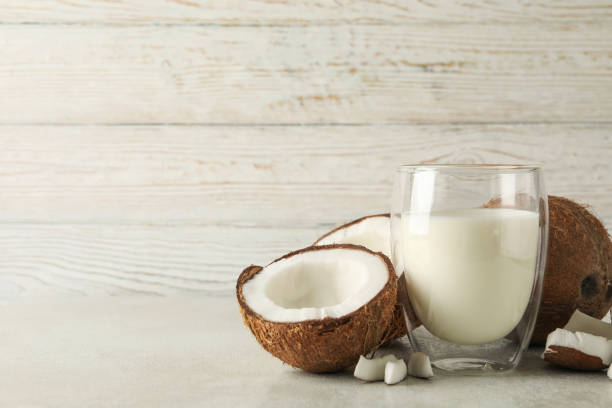 istock Fresh coconut and coconut milk on wooden background 1288959977