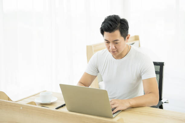 istock asian man working on desk with laptop 1288962800