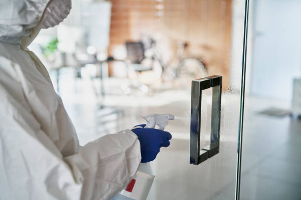 istock Close up human hands cleaning door in the office 1288964239