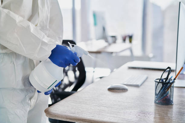 istock Close up human hands cleaning desk in the office 1288964439