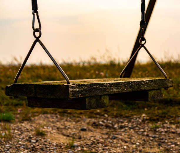 istock Old weathered swing made from wood planks, looking desolate. 1288964536