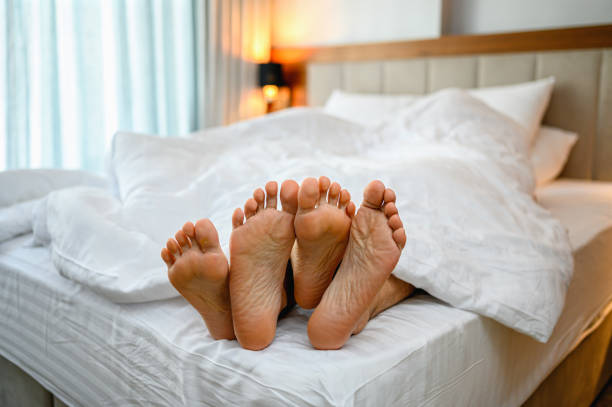 istock Couple foot on the bed. 1288965809